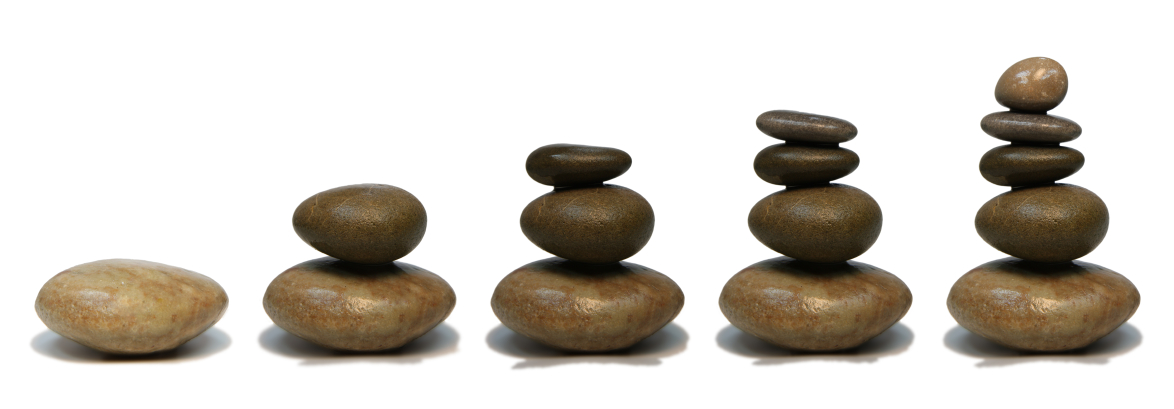 Header image of beach pebbles balanced into stacks